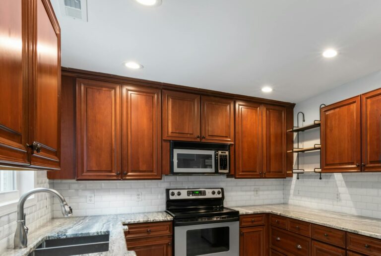 Elegant kitchen interior featuring wooden cabinetry and stainless steel appliances.