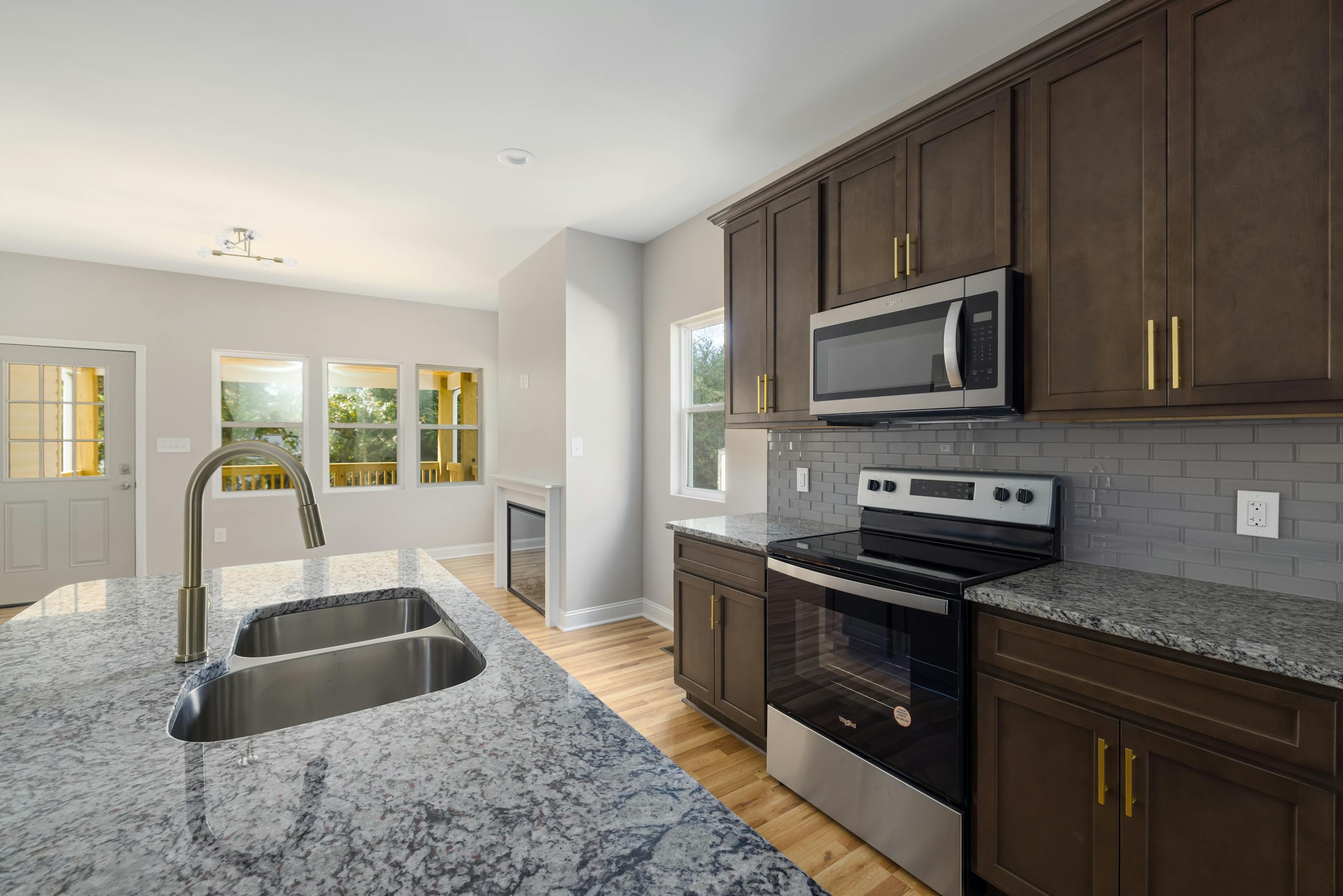Sleek kitchen design featuring granite countertops and stainless steel appliances.